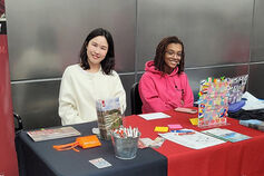 Students sitting at IUI Library information table.